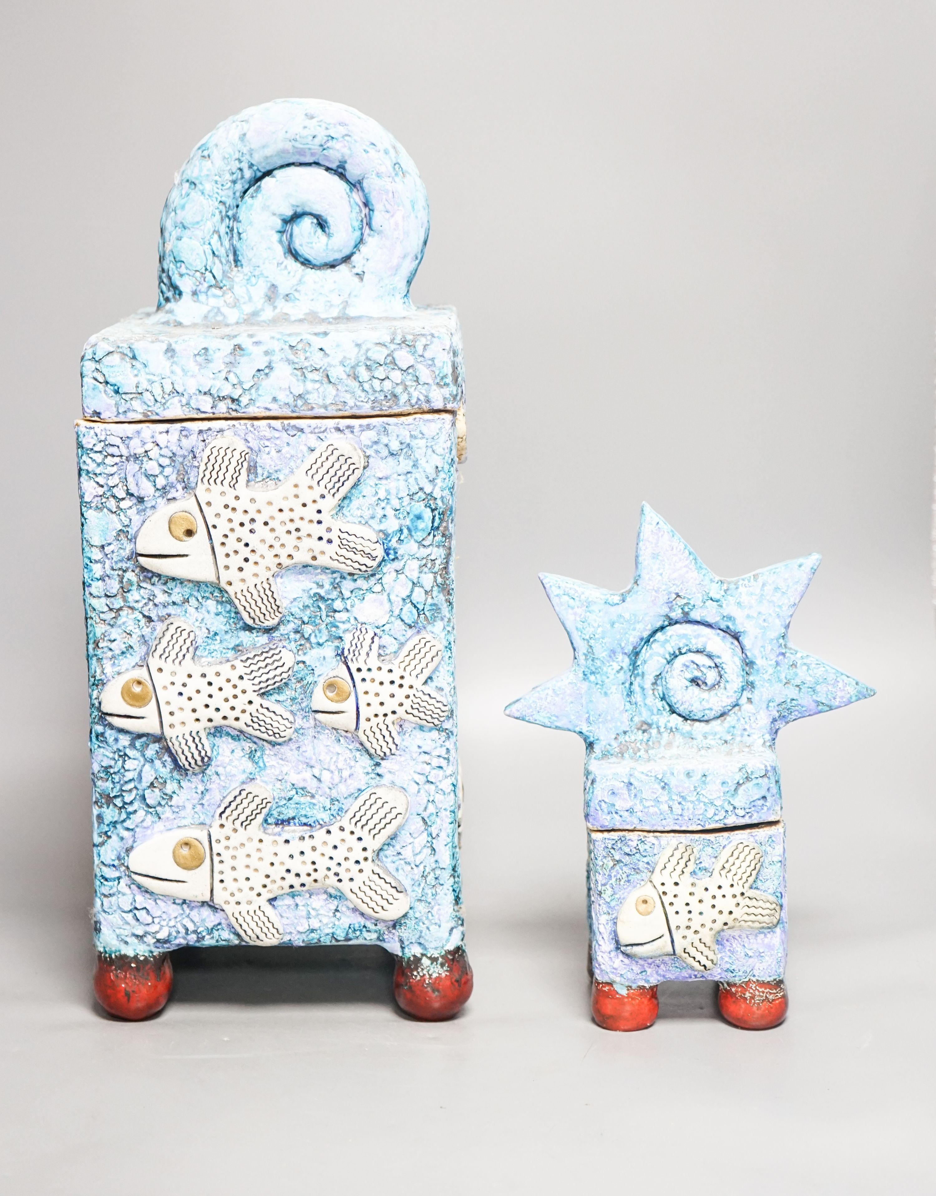 Gio Martin, a large square 'fish' jar and cover and a similar smaller jar and cover 44cm
